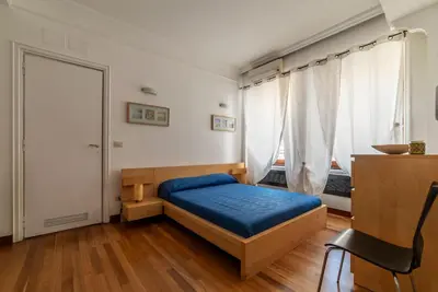 a bedroom with a blue bed and a window at GuestHost - Roma MM Repubblica Apartment in Rome