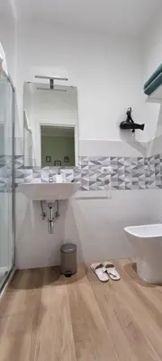 a bathroom with a sink and a mirror at Yuki Apartment in Rome
