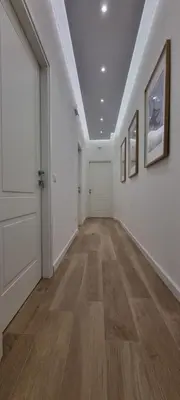 an empty hallway with white walls and wood floors at Yuki Apartment in Rome