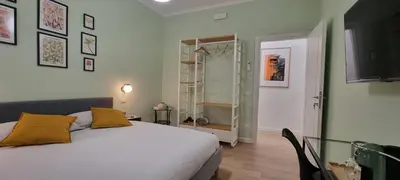 a bedroom with a bed with yellow pillows on it at Yuki Apartment in Rome