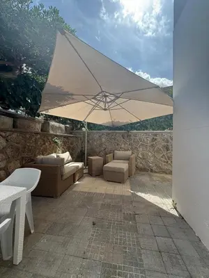 a large white umbrella sitting on a patio at La Martinella a Roma in Rome