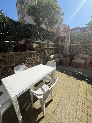 a white picnic table and two chairs and an umbrella at La Martinella a Roma in Rome