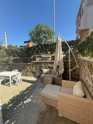 a patio with chairs and an umbrella and a table at La Martinella a Roma in Rome