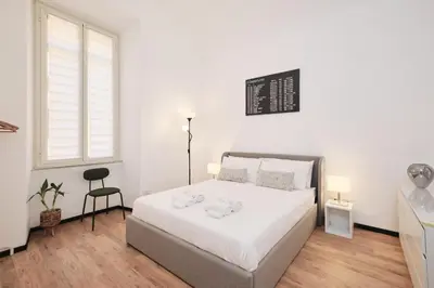 a white bedroom with a bed and a window at Termini Station 5 minutes - Free Wi-Fi & Netflix in Rome