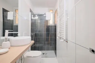 a bathroom with a sink and a toilet and a shower at Termini Station 5 minutes - Free Wi-Fi & Netflix in Rome