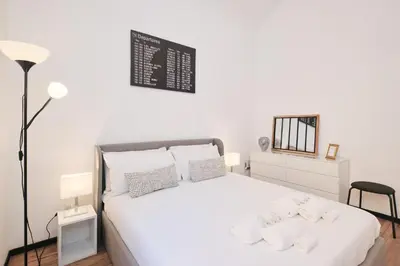 a bedroom with a large white bed with white pillows at Termini Station 5 minutes - Free Wi-Fi & Netflix in Rome