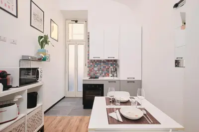 a kitchen with white cabinets and a white counter top at Termini Station 5 minutes - Free Wi-Fi & Netflix in Rome