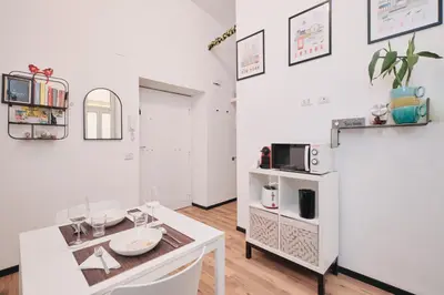 a kitchen with white walls and a table and a microwave at Termini Station 5 minutes - Free Wi-Fi & Netflix in Rome
