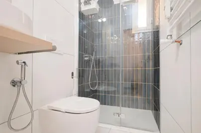 a bathroom with a toilet and a glass shower at Termini Station 5 minutes - Free Wi-Fi & Netflix in Rome