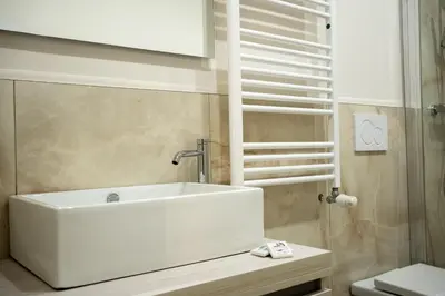 a bathroom with a white sink and a toilet at C&P Luxury Guest House Rome in Rome