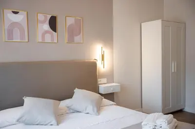 a bedroom with a white bed with two pillows at C&P Luxury Guest House Rome in Rome