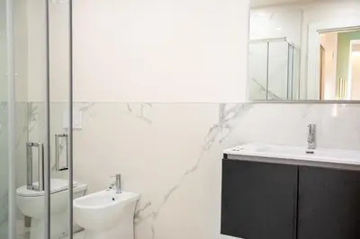 a bathroom with a sink and a toilet and a mirror at C&P Luxury Guest House Rome in Rome