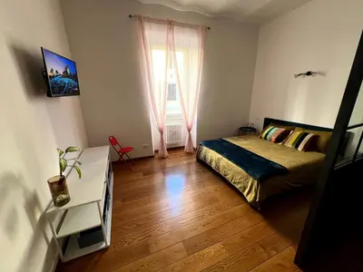 a kitchen with a counter and a table in a room at Nel cuore di San Lorenzo in Rome