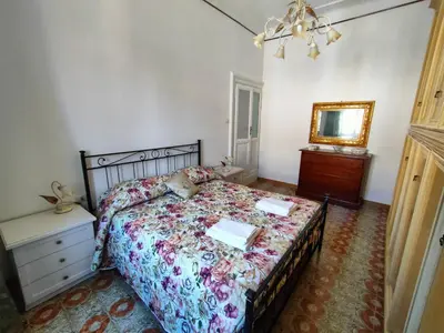 a bedroom with a bed and a dresser and a mirror at Romein5minutes in Rome