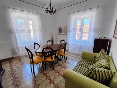 a dining room with a table and chairs and a couch at Romein5minutes in Rome