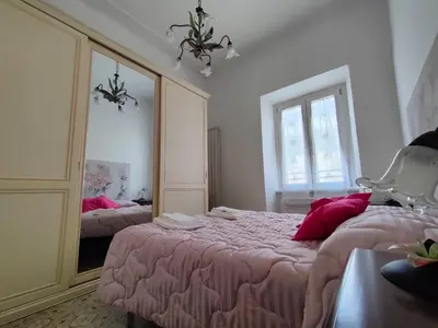 a bedroom with two beds and a large mirror at Romein5minutes in Rome