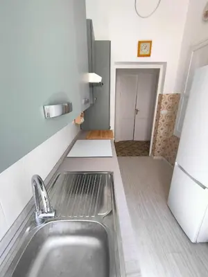 a kitchen with a sink and a refrigerator at Romein5minutes in Rome