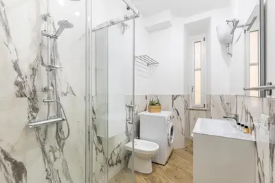 a bathroom with a shower and a toilet and a sink at Hostly-Suite Apartment Laterano-Walk to Colosseum in Rome
