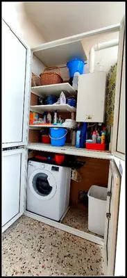 a kitchen with a washing machine in a refrigerator at Il Cupolone in Pineta - Two steps in the pinewood towards the Vatican! in Rome