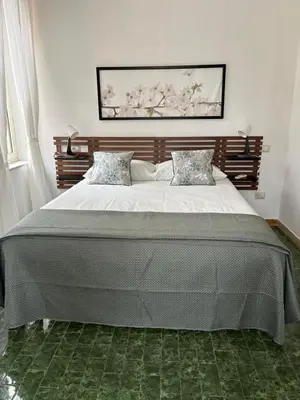 a bedroom with a large bed with two pillows at Ad Maiora Domus in Rome