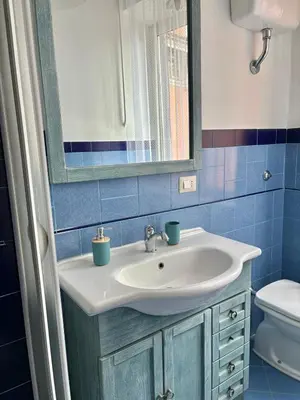 a bathroom with a sink and a mirror and a toilet at Ad Maiora Domus in Rome
