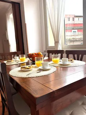 a wooden table with glasses of orange juice on it at Ad Maiora Domus in Rome
