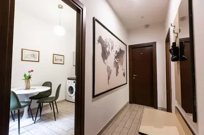 a hallway with a room with a table and a world map on the wall at Renovated 2-bdr flat Statuto - ZEN 51 in Rome