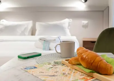 a table with a cup of coffee and a loaf of bread at Renovated 2-bdr flat Statuto - ZEN 51 in Rome