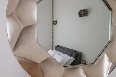 a mirror hanging on a wall in a room at Lux San Pietro Apartment in Rome
