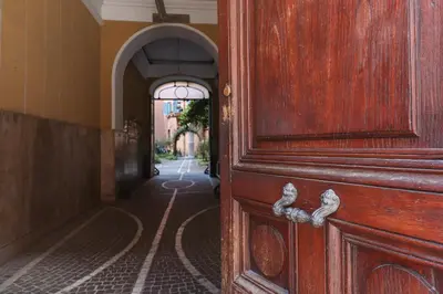 an entrance to a hallway with a wooden door at Lux San Pietro Apartment in Rome