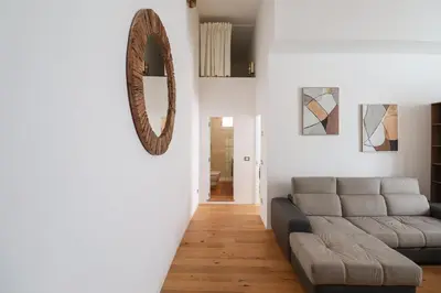 a living room with a couch and a mirror at Lux San Pietro Apartment in Rome