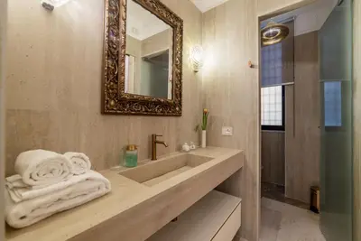 a bathroom with a sink and a mirror at Sinopia Home Gallery - WelcomeToRhome in Rome