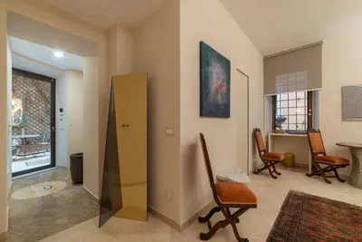 a living room with chairs and a table at Sinopia Home Gallery - WelcomeToRhome in Rome
