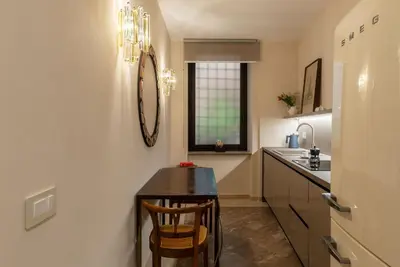 a kitchen with a small table and a sink at Sinopia Home Gallery - WelcomeToRhome in Rome
