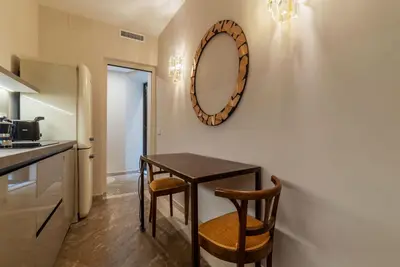 a kitchen with a table and two chairs and a mirror at Sinopia Home Gallery - WelcomeToRhome in Rome