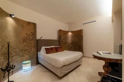 a bedroom with a bed and a desk in it at Sinopia Home Gallery - WelcomeToRhome in Rome
