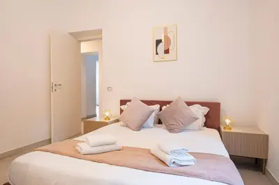 a bedroom with a large white bed with towels on it at San Pietro Apartment 66 in Rome