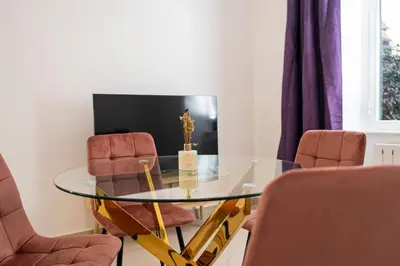 a dining room with a glass table and two chairs at San Pietro Apartment 66 in Rome