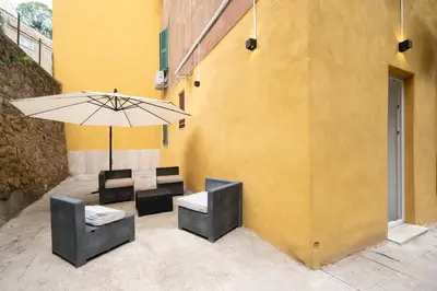 a patio with a table and chairs and an umbrella at San Pietro Apartment 66 in Rome