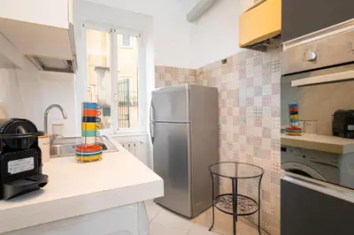 a kitchen with a stainless steel refrigerator in a kitchen at San Pietro Apartment 66 in Rome