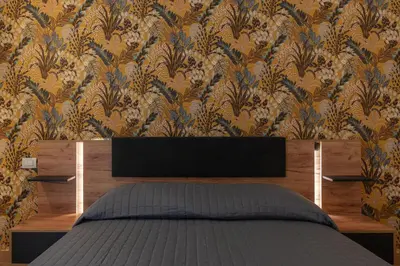 a bedroom with a bed and a floral wallpaper at GuestHost - Domus Antoniana - Esquilino in Rome