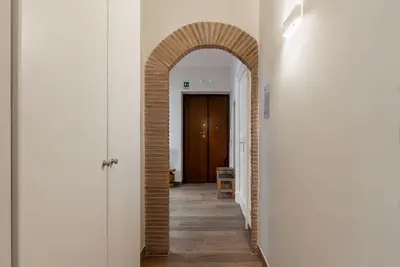 an arched hallway with an archway in a building at GuestHost - Domus Antoniana - Esquilino in Rome