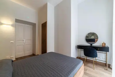 a bedroom with a bed and a desk at GuestHost - Domus Antoniana - Esquilino in Rome