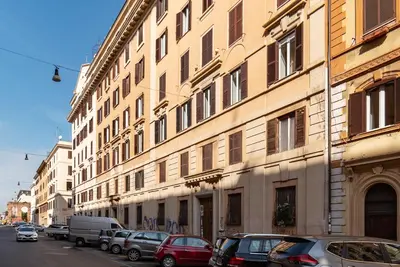 a large building with cars parked in front of it at GuestHost - Domus Antoniana - Esquilino in Rome