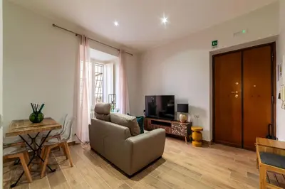 a living room with a couch and a television at GuestHost - Domus Antoniana - Esquilino in Rome