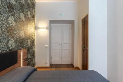 a bedroom with a bed and a white door at GuestHost - Domus Antoniana - Esquilino in Rome
