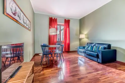 a living room with a couch and a table at Casa Nina Ostiense - Roma Tre - by GHOR in Rome