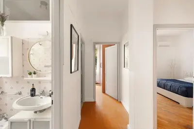 a white bathroom with a sink and a bed at San Paolo Private Garden Home in Rome