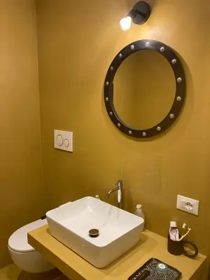 a bathroom with a white sink and a mirror at Bright Apartment in San Lorenzo - Feel at Home in Rome