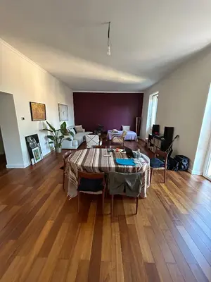 a living room with a table and a couch at Bright Apartment in San Lorenzo - Feel at Home in Rome